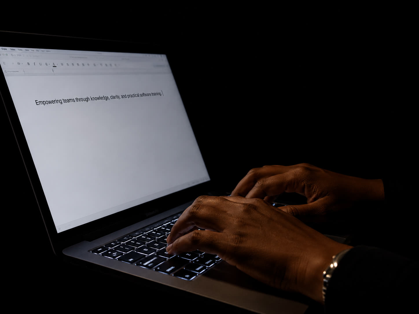 Hands typing a brief into a laptop at night